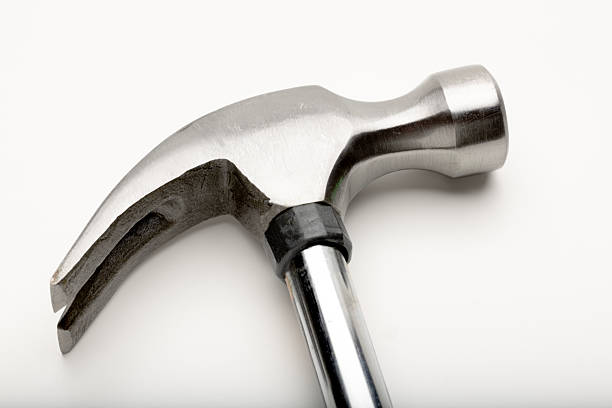 istock A close-up of a metallic hammer with a smooth handle and a curved claw. 2221521154