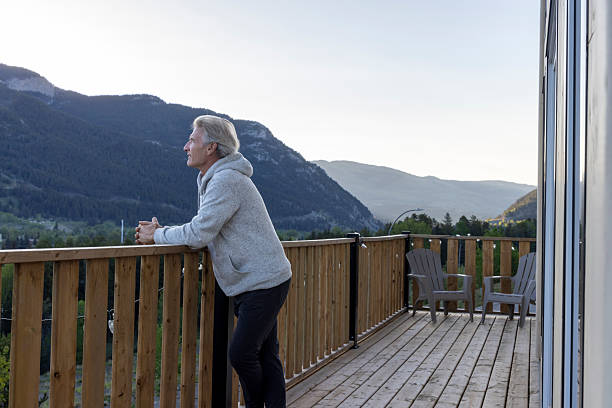 istock Mature man enjoys hot beverage on deck at sunrise 2221521194