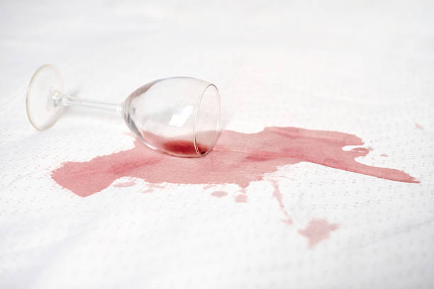 istock Red wine glass spill on white fabric surface 2221522490
