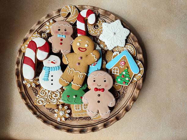 Gingerbread cookies with icing on a plate. Christmas food. Gingerbread man. Top view copy space.