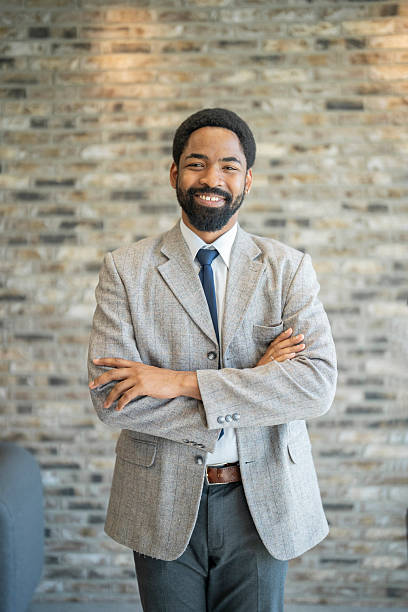istock Confident businessman smiling with folded arms in modern office 2221524937