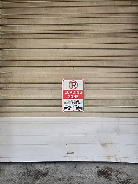 No Parking Loading Zone Sign on Industrial Garage Door