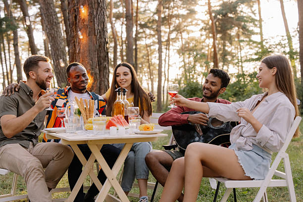 istock Friends toasting, enjoying picnic in a pine forest 2221538195