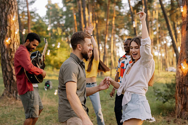 istock Interracial friends dancing and playing guitar at a forest party 2221540733