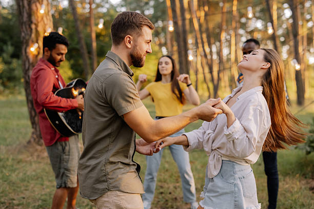 istock Interracial friends dancing and playing guitar at a forest party 2221540734