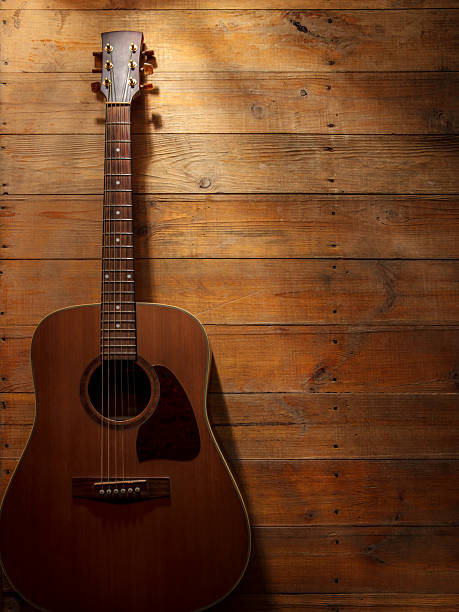 istock Acoustic guitar on a wooden background with space for copy 2221545578