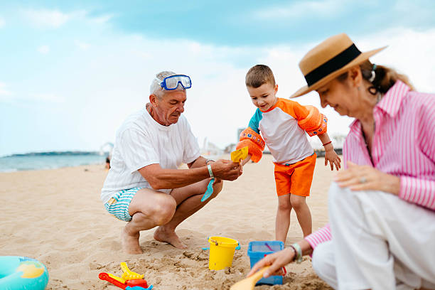 istock Playing in the sand with my grandparents 2221549169