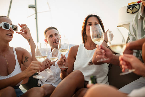 istock Friends toasting with white wine on sailboat at sunset 2221554036