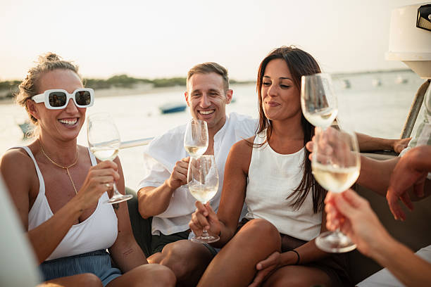 istock Friends enjoying wine on a boat trip at sunset 2221554052