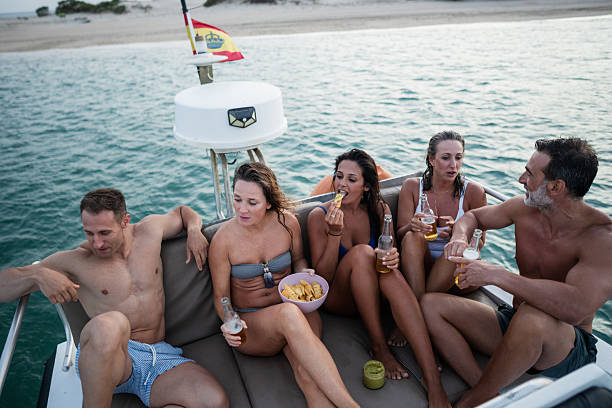 istock Friends enjoying drinks and snacks on a boat trip in spain 2221558700