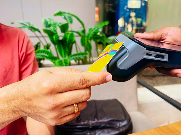 istock Man making contactless payment with card at cafe 2221562285