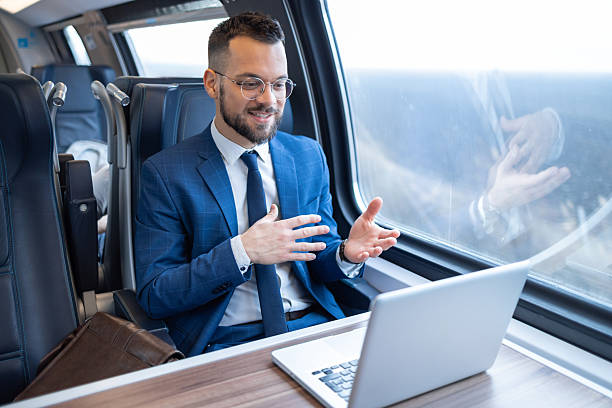 istock Young businessman having a video call while traveling by train 2221564308
