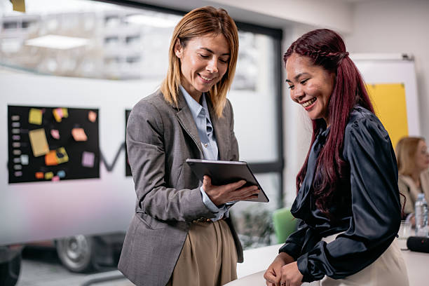 istock Two professional women discussing ideas while collaborating in a modern office environment 2221564422