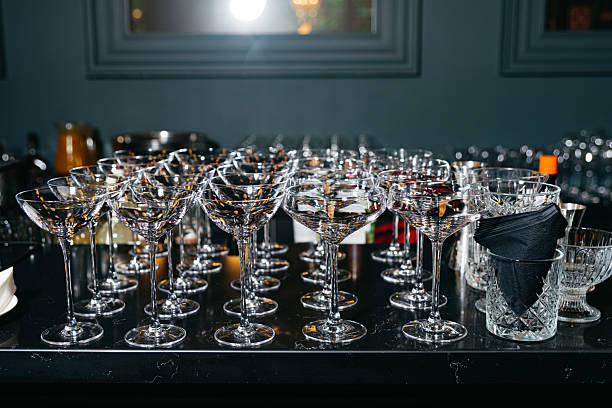 istock Empty cocktail glasses arranged on bar counter. 2221568976