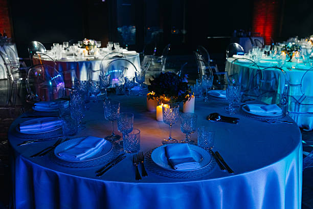 istock Elegant candlelit dinner tables at evening event. 2221568991