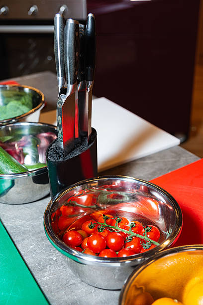 istock Fresh cherry tomatoes in kitchen prep station. 2221569216