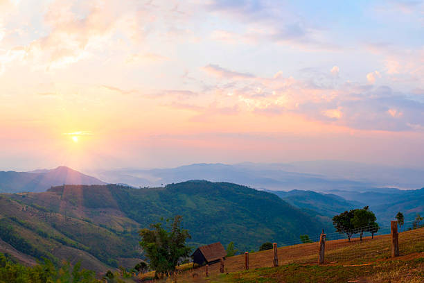 Scenic view dramatic beautiful sunset sky. Natural Sunset Sunrise on meadow silhouette shadow dark land. Vibrant dramatic sky on sunset, dawn, sunrise in Countryside. Landscape Colorful Sky At Sunset