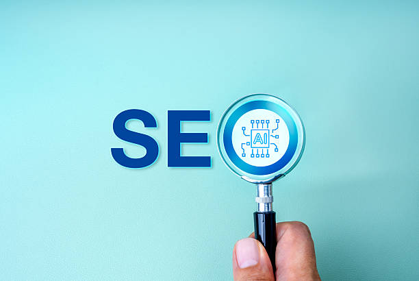 SEO optimization, search engine marketing, with Artificial intelligence assistant tools technology concept. AI chip focused in magnifying glass lens in people hand, with text SEO, on blue background. SEO optimization, search engine marketing, with Artificial intelligence assistant tools technology concept. AI chip focused in magnifying glass lens in people hand, with text SEO, on blue background. SEO stock pictures, royalty-free photos & images