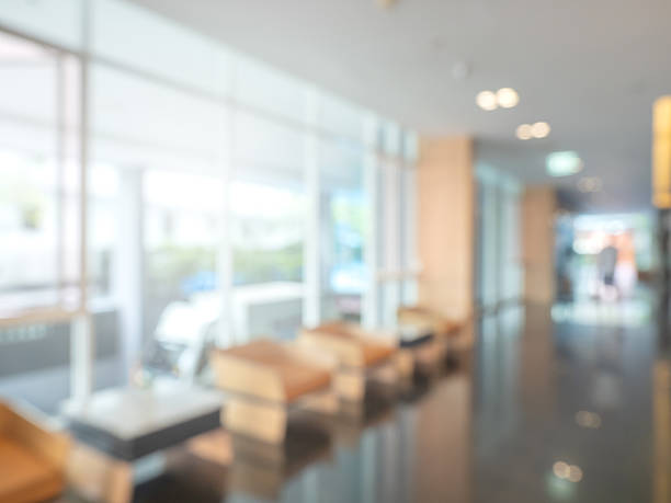 istock Abstract blur luxury hotel background, lobby reception area interior, decoration with sofa couch near glass partition, lights, marble floors. Blurred scene interior design, business travel concept. 2221582526