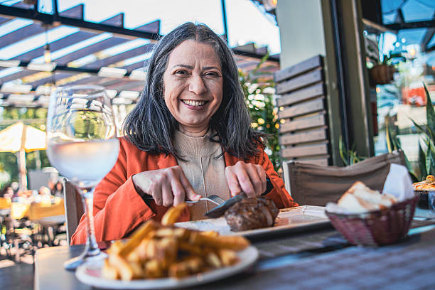 Woman eating steak with potatoes in Argentina