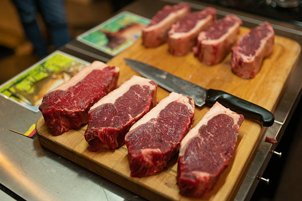 istock Steak Comparison USA vs Germany, raw sliced beef with beetroot on plate 2221595668