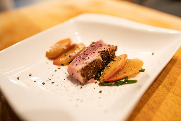 istock Grilled tuna fillet served with fresh peach slices on rustic plate 2221596153
