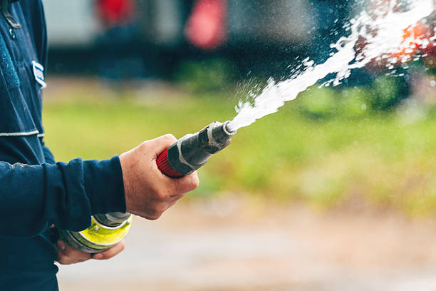 istock Firefighter spraying water from the hose 2221597176