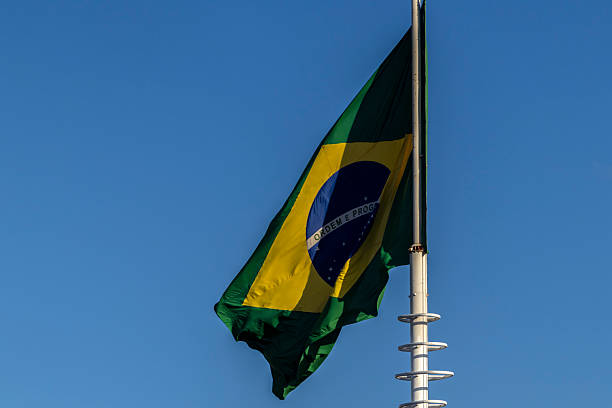 istock Brazilian flag waving against a clear blue sky 2221598751
