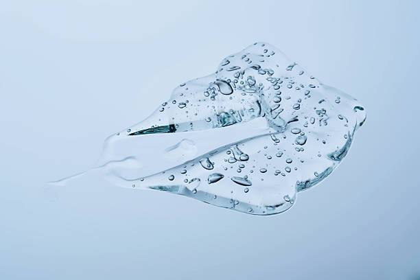 istock A smear of gel serum texture on a blue background. 2221599028