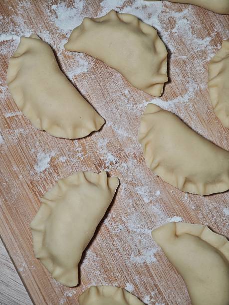 istock Make dumplings, raw dumplings on a board sprinkled with flour 2221599438