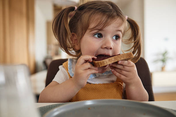 Beautiful girl eating jam stock photo