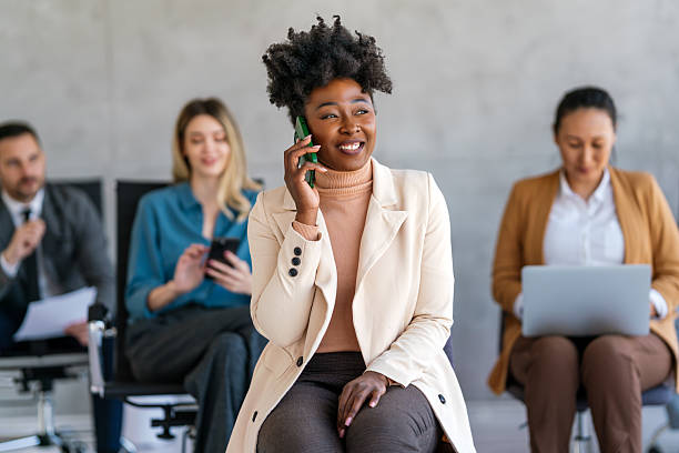 istock Busy smiling executive business team using digital devices in office. Diverse professional people 2221602623