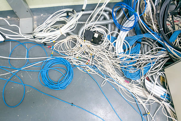 ELECTRICAL AND TELEPHONE CABLES mounted externally on a building wall
