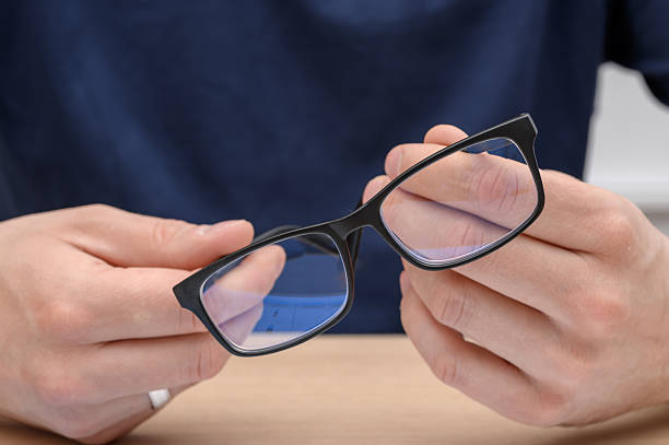 istock A man holds prescription glasses in his hand, visual impairment 2221606962