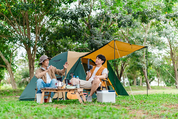 istock Friends Relaxing at Campsite 2221607785