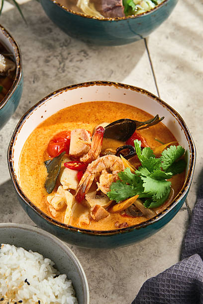 istock Tom yam seafood soup, bright natural light, overhead composition, served in rustic ceramic bowl 2221608172