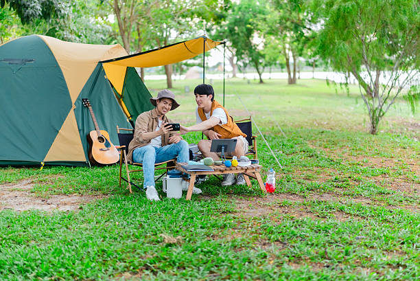 istock Friends Relaxing at Campsite 2221608197