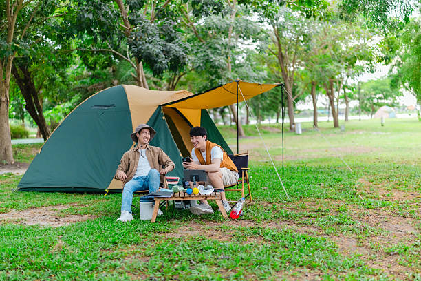 istock Friends Relaxing at Campsite 2221608208