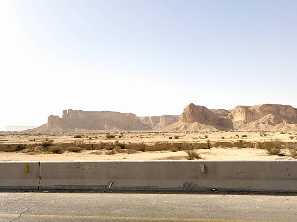 The rolling sand dunes, rocky cliffs, and dry terrain capture the raw beauty of the Arabian Peninsula’s arid environment.