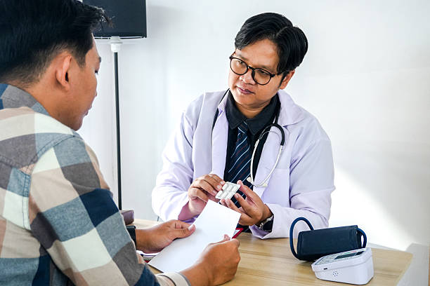 istock Physician Recommend Pills to Male Patient 2221608231