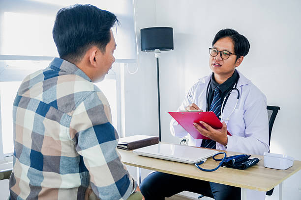 istock Physician Talking to Man at Appointment Visit 2221608293