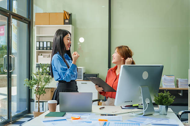 istock Two young female business consultants work on startup, collaborating on mobile app development social media strategies. whiteboards, documents, they aim to build a successful e-commerce business. 2221608933