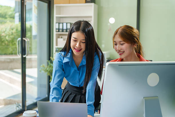 istock Two young female business consultants work on startup, collaborating on mobile app development social media strategies. whiteboards, documents, they aim to build a successful e-commerce business. 2221608935