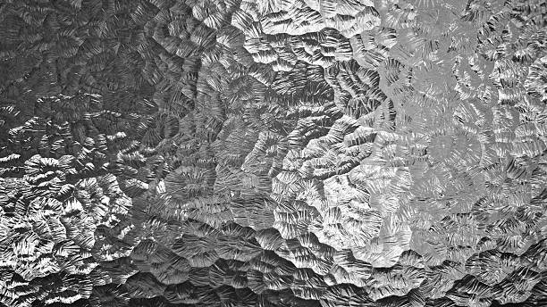 istock Shiny textured silver gray metallic hammer tone embossed aluminum foil surface abstract pattern background 2221608946