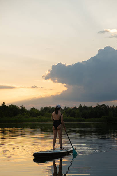 istock Paddleboarding at Sunset on a Tranquil Lake 2221609882