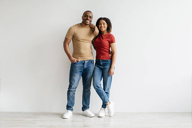 istock Cheerful young Black couple standing together against plain white wall 2221614246