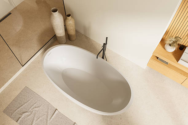 istock Modern minimalistic bathroom interior with oval standalone bathtub, natural textures, and neutral tones viewed from top perspective. 3D Rendering 2221615772