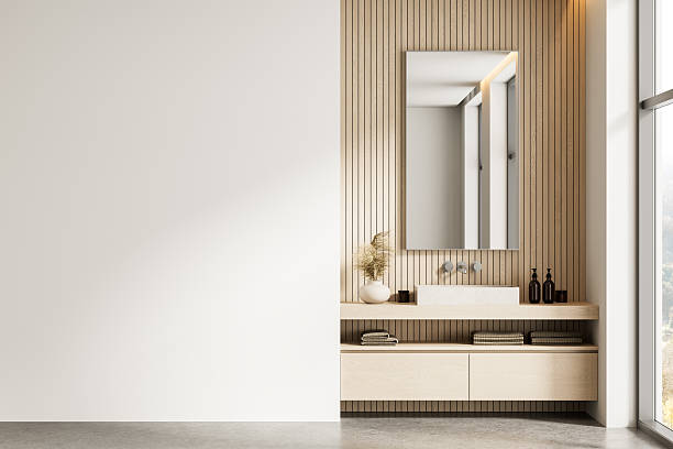 istock Modern bathroom interior with wooden panel wall, mirror, and clean white space for poster mockup or template display on left side of image wall. 3D Rendering 2221616093