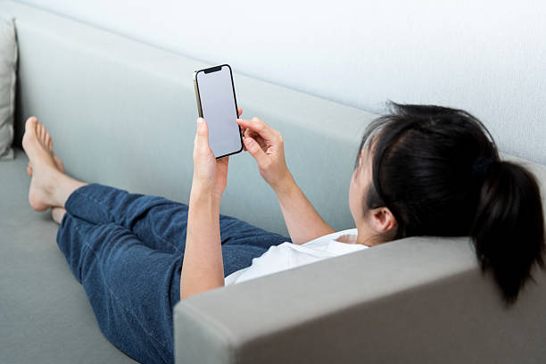 istock The woman sitting on sofa and using phone 2221616267