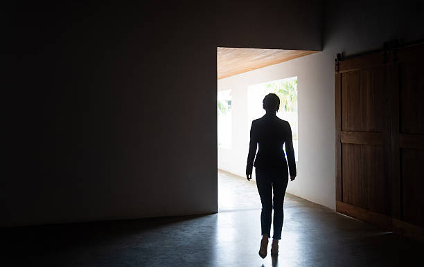 istock Woman walking to the bright corridor 2221616607